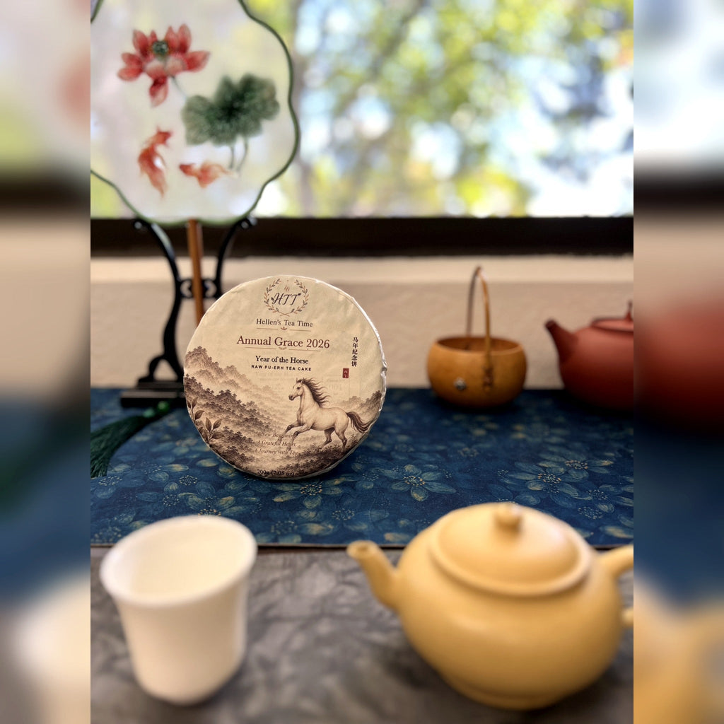 Annual Grace 2026 raw pu-erh tea cake on a Chinese tea table