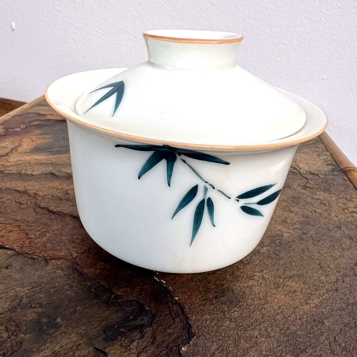 Bamboo gaiwan on stone surface for tea brewing
